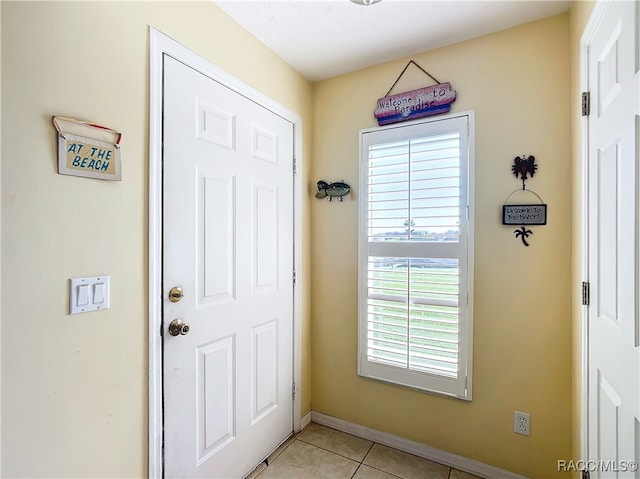 doorway with light tile patterned floors