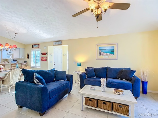 tiled living room featuring a textured ceiling, ceiling fan with notable chandelier, and lofted ceiling