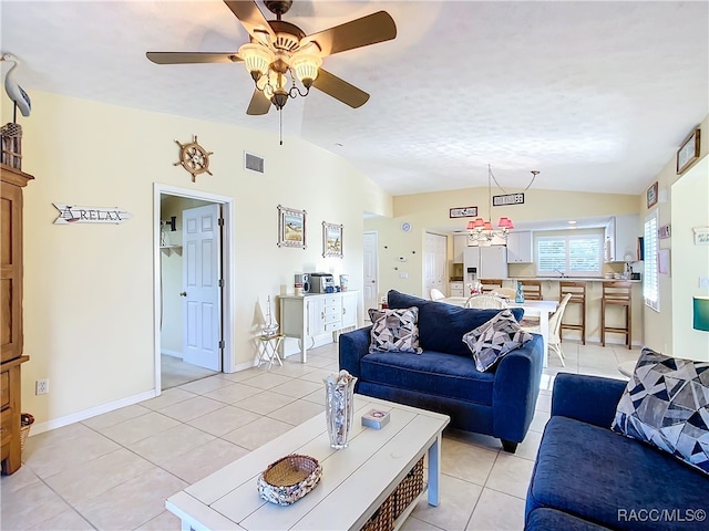 living room featuring ceiling fan, light tile patterned flooring, and lofted ceiling