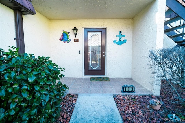 doorway to property with stucco siding