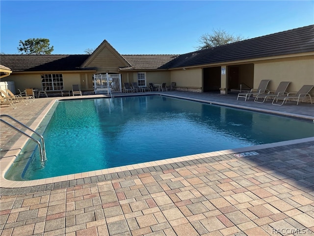 view of swimming pool featuring a patio area