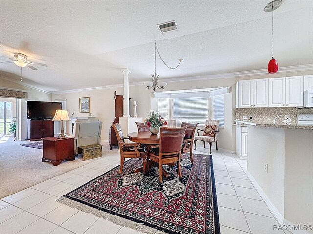 dining area featuring light tile patterned floors, a skylight, and crown molding