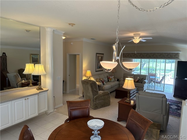 tiled dining space featuring ceiling fan, ornamental molding, and ornate columns