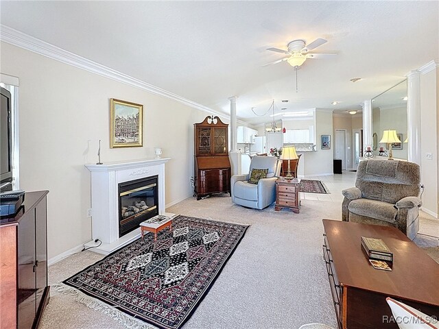 tiled dining room with a healthy amount of sunlight, ceiling fan with notable chandelier, and ornamental molding