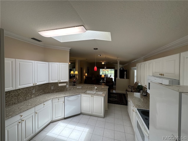 kitchen with kitchen peninsula, light tile patterned flooring, white appliances, white cabinetry, and a textured ceiling