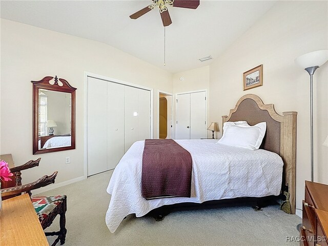 bedroom with vaulted ceiling, ceiling fan, and light colored carpet