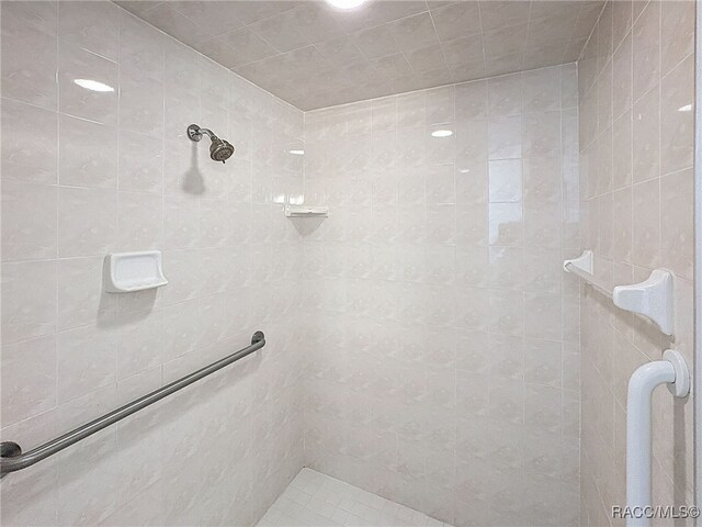 bathroom with toilet, vanity, tile patterned flooring, and a shower with door