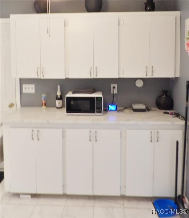 127 N Braemar Dr, Inverness, FL 34450 - kitchen with light countertops, light tile patterned floors, and white cabinets