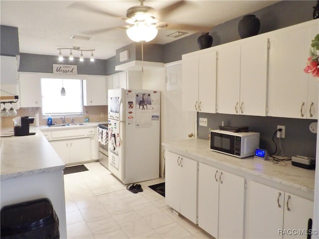 127 N Braemar Dr, Inverness, FL 34450 - kitchen with freestanding refrigerator, black microwave, ceiling fan, light countertops, and electric stove