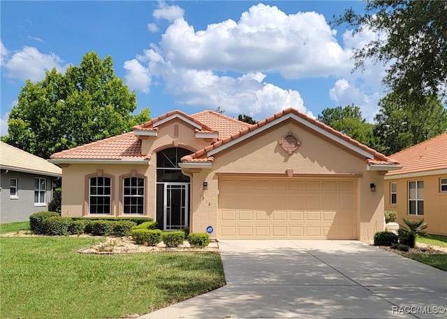 mediterranean / spanish home with a garage and a front yard