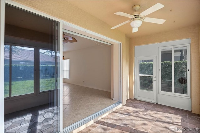 doorway to outside with ceiling fan