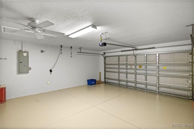 garage with a garage door opener, electric panel, and ceiling fan