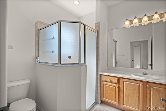 bathroom featuring toilet, a shower with door, and vanity