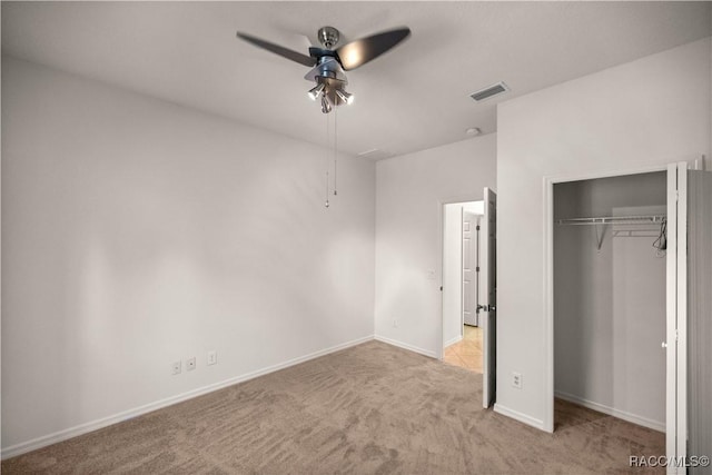 unfurnished bedroom featuring a closet, ceiling fan, and light carpet