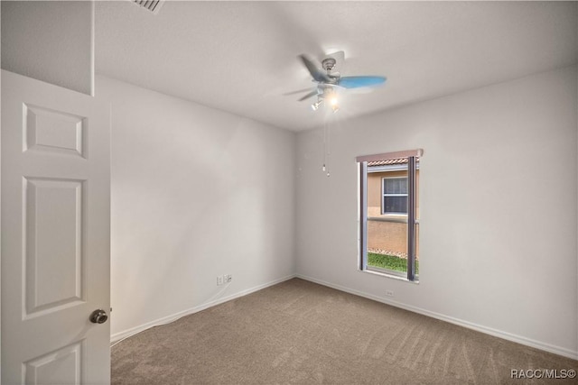 spare room featuring ceiling fan and carpet floors