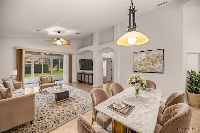 tiled dining space with vaulted ceiling and ceiling fan