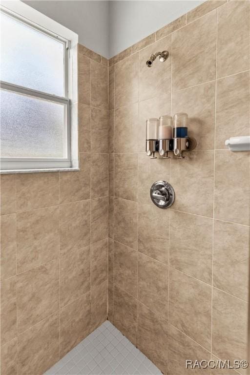 bathroom with tiled shower