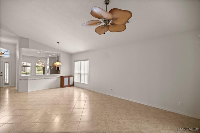 unfurnished living room featuring ceiling fan, light tile patterned floors, and vaulted ceiling