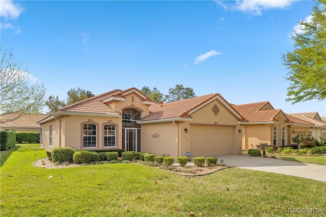 mediterranean / spanish house featuring a garage and a front lawn