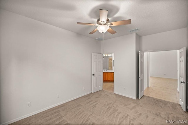 unfurnished bedroom with light carpet and ceiling fan