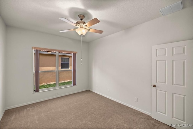 carpeted spare room with ceiling fan