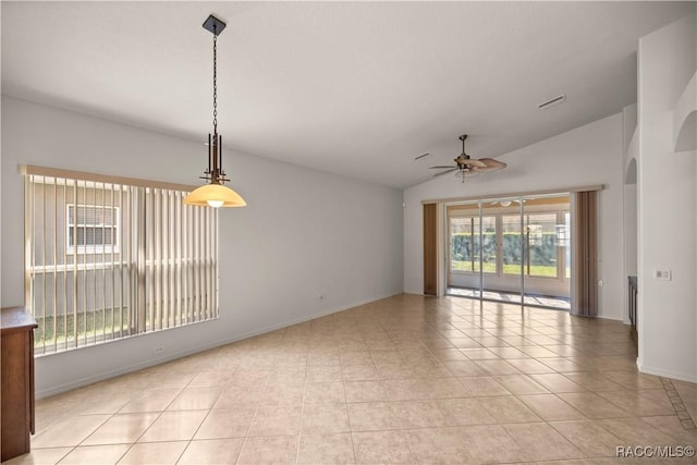 spare room featuring ceiling fan, lofted ceiling, and light tile patterned flooring