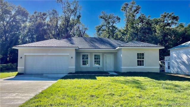 ranch-style home with a garage, a front yard, concrete driveway, and stucco siding