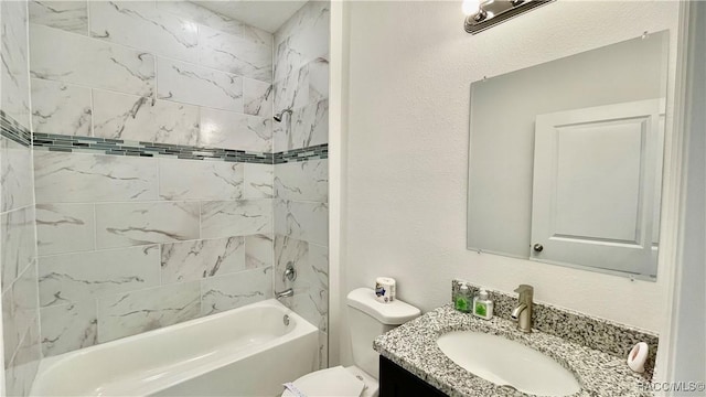 full bath featuring shower / washtub combination, a textured wall, vanity, and toilet