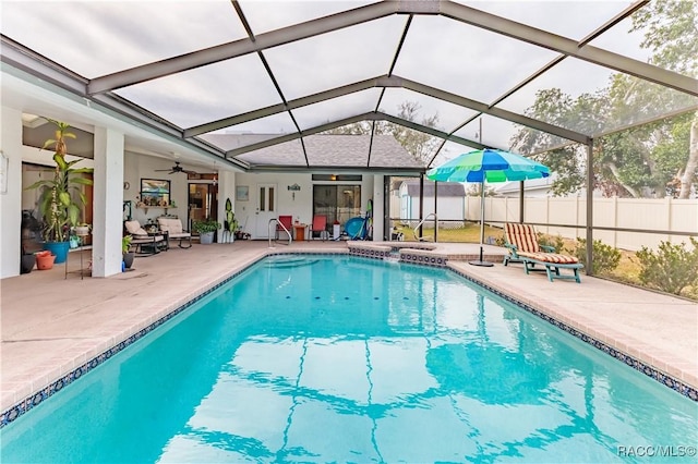 view of pool featuring ceiling fan, a lanai, and a patio