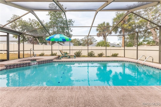 view of swimming pool featuring an in ground hot tub, a patio, sink, and glass enclosure