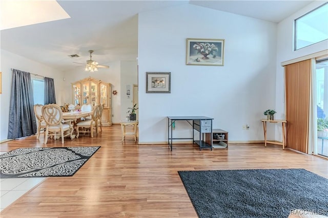 interior space featuring wood-type flooring, ceiling fan, and vaulted ceiling