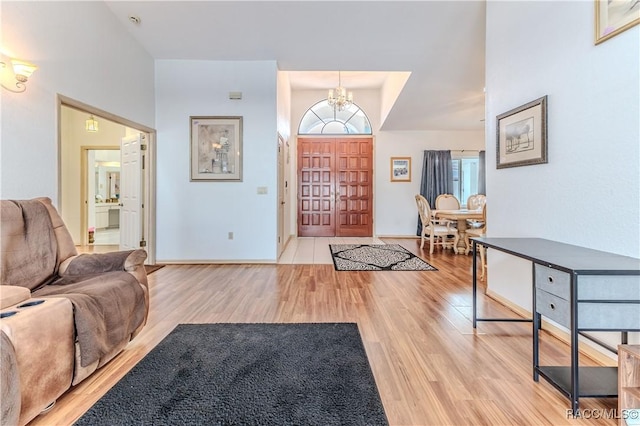 entryway featuring a chandelier and light hardwood / wood-style floors