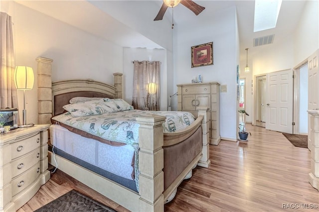 bedroom with ceiling fan and light wood-type flooring