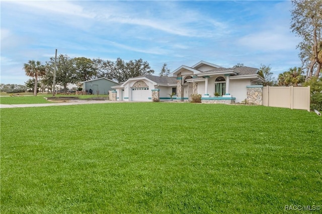 view of front of home featuring a garage and a front yard