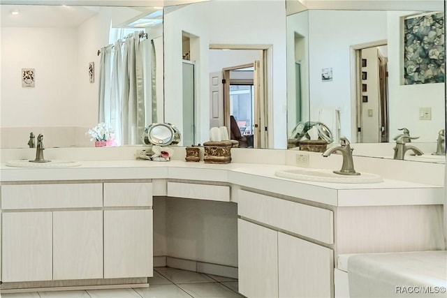 bathroom featuring vanity, tile patterned floors, and walk in shower