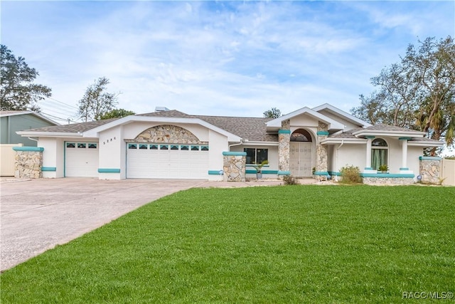 single story home with a garage and a front lawn