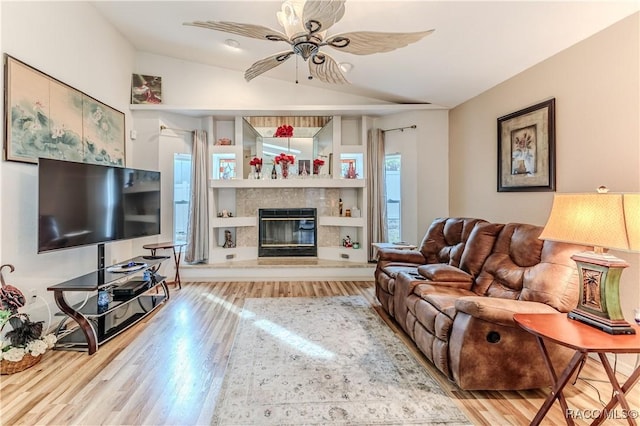 living room with vaulted ceiling, ceiling fan, and light hardwood / wood-style flooring