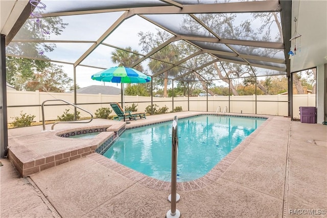 view of pool featuring a patio, an in ground hot tub, and glass enclosure