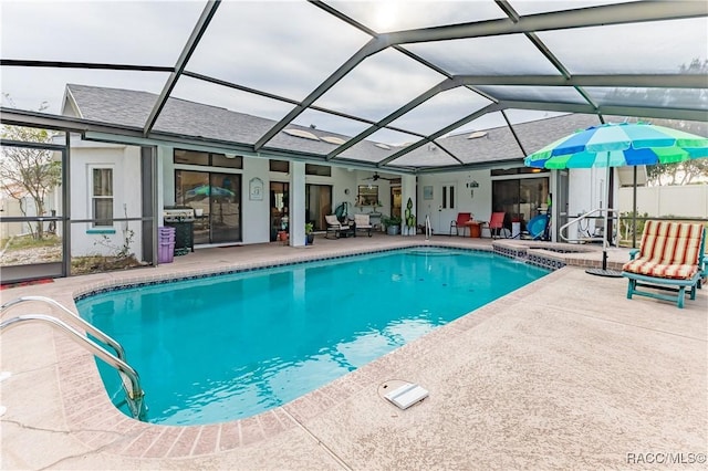 view of swimming pool featuring a patio area and glass enclosure