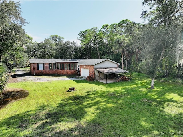 single story home with a front yard and a garage