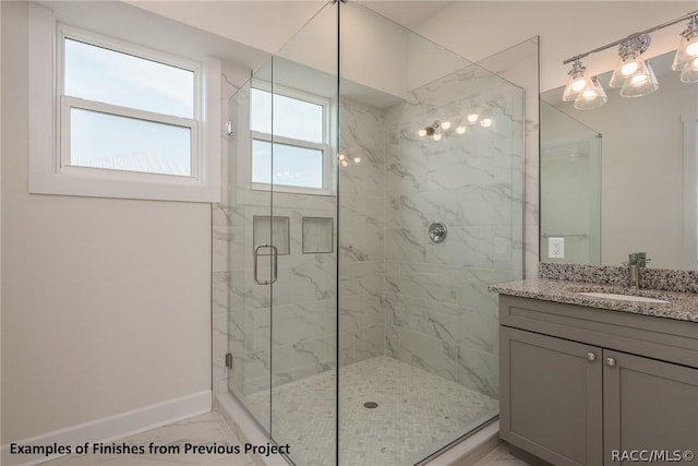 bathroom featuring vanity and a shower with shower door