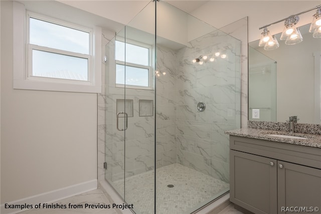 bathroom with vanity and a shower with shower door