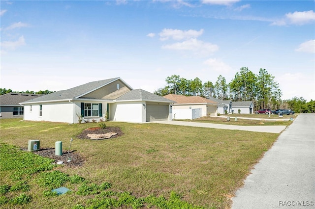 ranch-style home featuring a garage and a front yard