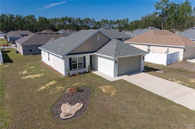 view of front of house featuring a garage and a front lawn