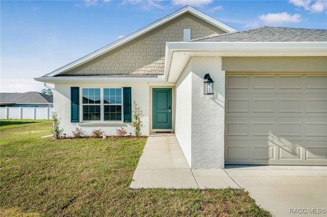 view of front of property with a garage and a front lawn