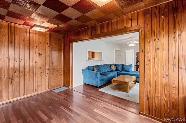 living room with wooden walls, hardwood / wood-style floors, ceiling fan, and wooden ceiling