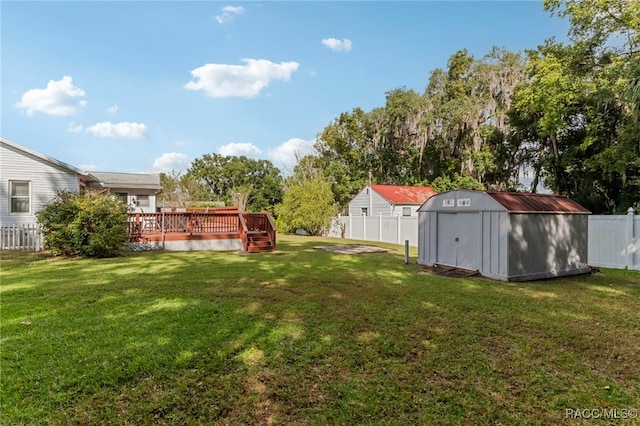 view of yard with a deck and a storage shed