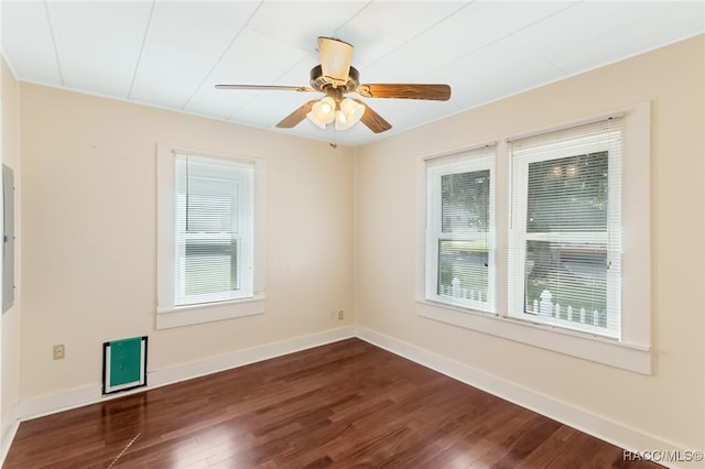 unfurnished room featuring ceiling fan, dark hardwood / wood-style flooring, and a wealth of natural light