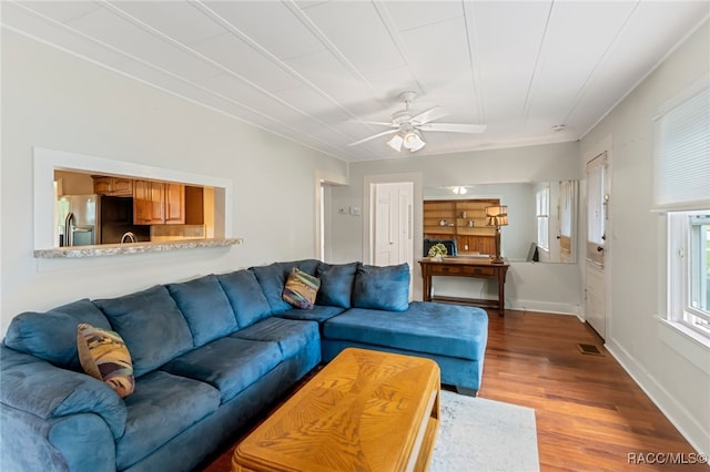 living room featuring hardwood / wood-style floors and ceiling fan