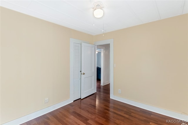 unfurnished room featuring dark hardwood / wood-style flooring